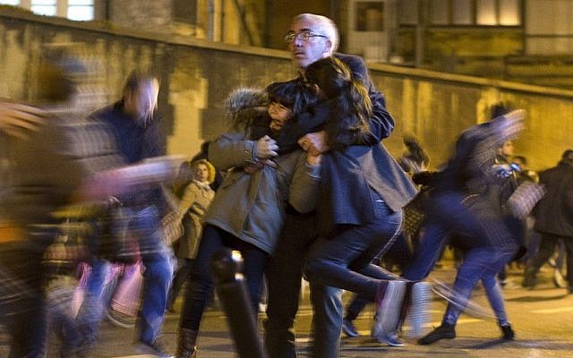 A man carries two children after panic broke out among mourners who payed their respect at the attack sites at restaurant Le Petit Cambodge (Little Cambodia) and the Carillon Hotel in Paris, Sunday, Nov. 15, 2015. (AP Photo/Peter Dejong) A man carries two children after panic broke out among mourners who payed their respect at the attack sites at restaurant Le Petit Cambodge (Little Cambodia) and the Carillon Hotel in Paris, Sunday, Nov. 15, 2015. (AP Photo/Peter Dejong)