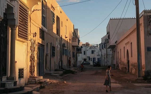 A girl walks home after sunset, at Hara Kbira, the main Jewish neighborhood on the Island of Djerba, southern Tunisia, October 29, 2015. (Photo by AP Photo/Mosa'ab Elshamy)