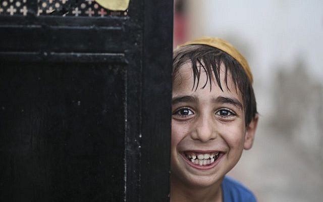 A student wearing a Kippah poses for the camera as he leaves the main Talmudic school at Hara Kbira, the main Jewish neighborhood on the Island of Djerba, southern Tunisia, October 29, 2015. (Photo by AP Photo/Mosa'ab Elshamy)