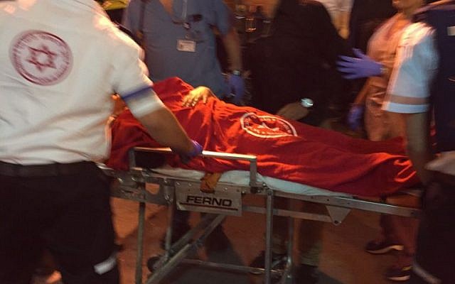 Medics provide medical care to victims injured in a stabbing attack in Kiryat Gat on November 21, 2015. (Magen David Adom) Medics provide medical care to victims injured in a stabbing attack in Kiryat Gat on November 21, 2015. (Magen David Adom)