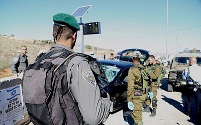 Border Police officers and IDF soldiers arrive on the scene of a car ramming attack at Tapuah Junction in the West Bank on November 24, 2015. (Israel Police) Border Police officers and IDF soldiers arrive on the scene of a car ramming attack at Tapuah Junction in the West Bank on November 24, 2015. (Israel Police)