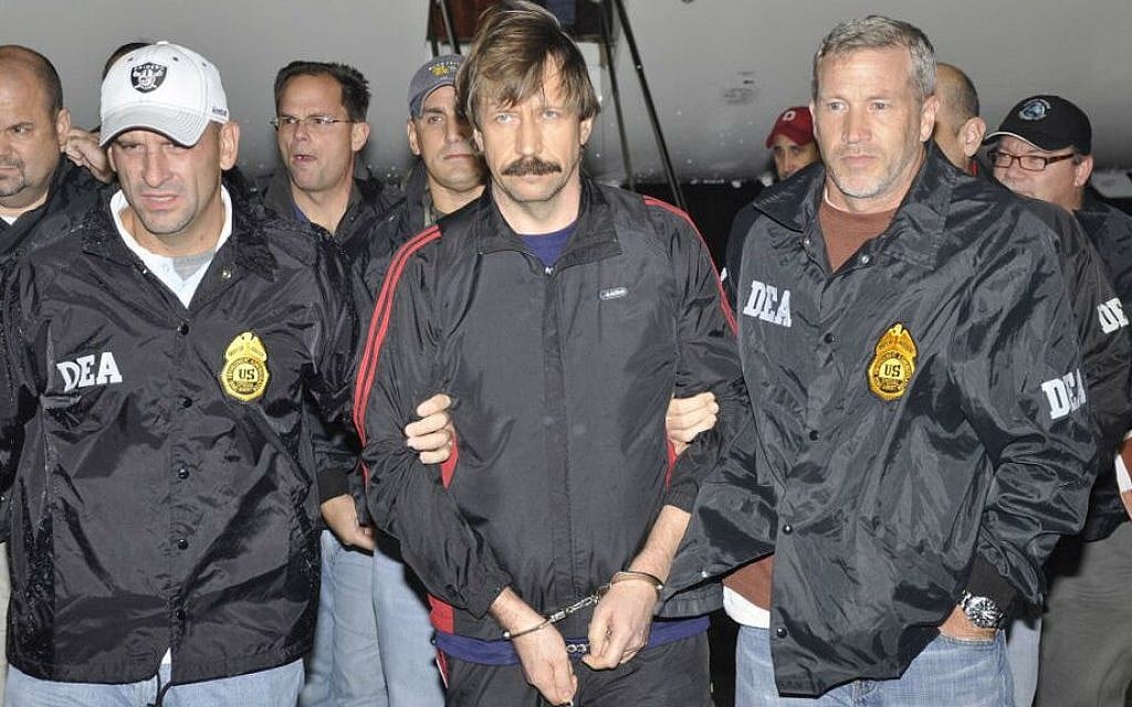 Suspected Russian arms dealer Viktor Bout (center) is escorted by US Drug Enforcement Administration (DEA) officers after arriving in New York, November 16, 2010. (Courtesy of DEA)
