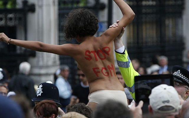 File: In this Monday, July 7, 2014 photo, a British police officer arrests an activist from the FEMEN group as she shouts slogans against female genital mutilation during a protest opposite the Houses of Parliament in central London. (AP Photo/Lefteris Pitarakis, File) File: In this Monday, July 7, 2014 photo, a British police officer arrests an activist from the FEMEN group as she shouts slogans against female genital mutilation during a protest opposite the Houses of Parliament in central London. (AP Photo/Lefteris Pitarakis, File)