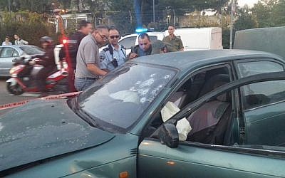 Security officers stand next to a car used in a shooting attack in the West Bank on Thursday, November 19, 2015 (Gush Etzion municipality) Security officers stand next to a car used in a shooting attack in the West Bank on Thursday, November 19, 2015 (Gush Etzion municipality)