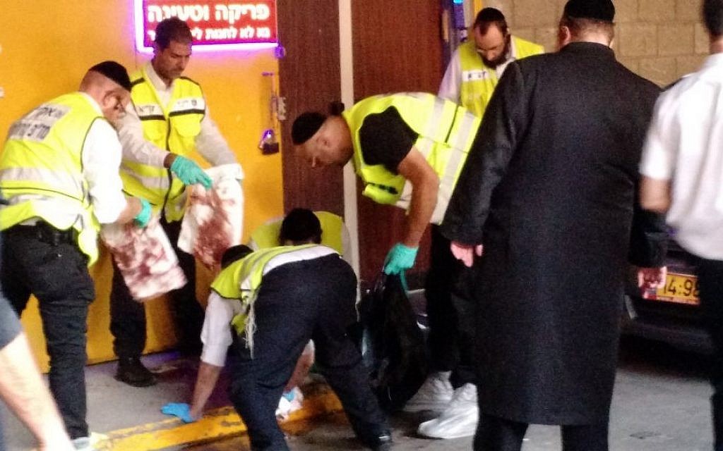 Members of the independent emergency service ZAKA cleaning blood at the scene of a stabbing attack in Tel Aviv on November 19, 2015. (Judah Ari Gross/ Times of Israel) Members of the independent emergency service ZAKA cleaning blood at the scene of a stabbing attack in Tel Aviv on November 19, 2015. (Judah Ari Gross/ Times of Israel)