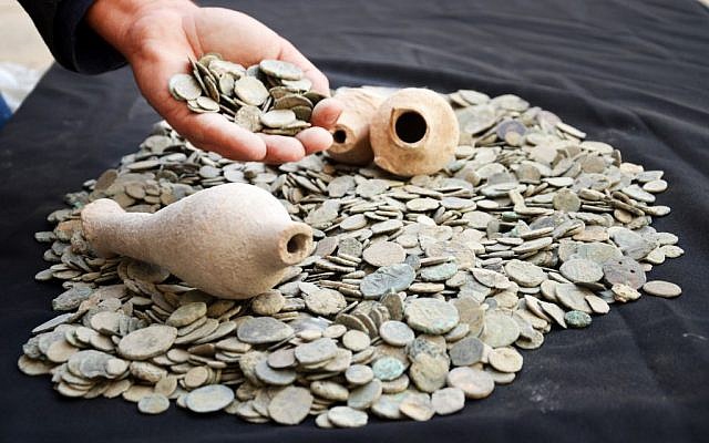 Ancient coins and jars confiscated from an antiquities dealer in northern Israel suspected of illegal sale of artifacts on November 24, 2015. (Israel Antiquities Authority) Ancient coins and jars confiscated from an antiquities dealer in northern Israel suspected of illegal sale of artifacts on November 24, 2015. (Israel Antiquities Authority)