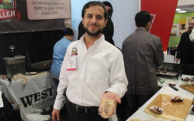 Pelleh Poultry CEO Eliezer Franklin holding squab, or pigeon meat, at Kosherfest in Secaucus, N.J., held on Nov. 10-11, 2015. (Photo by Uriel Heilman/JTA)