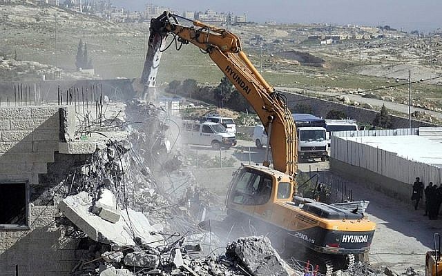 Illustrative: Bulldozers of the Jerusalem Municipality destroy a Palestinian house in the East Jerusalem neighborhood of A-Tur on March 26, 2014. (Sliman Khader/Flash90) Illustrative: Bulldozers of the Jerusalem Municipality destroy a Palestinian house in the East Jerusalem neighborhood of A-Tur on March 26, 2014. (Sliman Khader/Flash90)