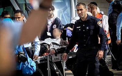 Israeli medics and emergency personnel evacuate an injured light rail security guard from the scene of a stabbing in the Jerusalem neighborhood of Pisgat Zeev, November 10, 2015. (Photo by Muammar Awad/Flash90)