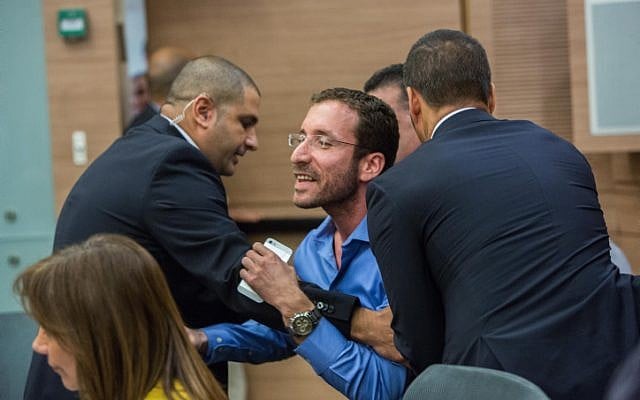 Israeli parliament member Itzik Shmuli is escorted out from a debate regarding the Israeli Jewish anti-assimilation 'Lehava' organization at the Interior Affairs committee meeting in the Knesset on November 10, 2015. (Yonatan Sindel/FLASH90 )