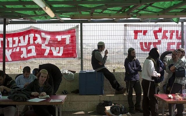 Right wing activists seen at the Ayelet Hashahar synagogue in the West Bank settlement of Givat Ze'ev, sit in front of signs reading "Stop the discrimination of the High Court," on November 16, 2015. (Lior Mizrahi/Flash90) Right wing activists seen at the Ayelet Hashahar synagogue in the West Bank settlement of Givat Ze'ev, sit in front of signs reading "Stop the discrimination of the High Court," on November 16, 2015. (Lior Mizrahi/Flash90)