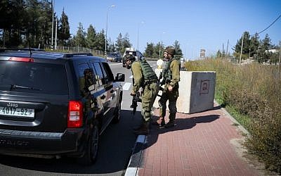 IDF soldiers inspect a Palestinian vehicle at a temporary checkpoint set up near the Jewish settlement of Alon Shvut, in the Etzion Bloc of the West Bank on November 22, 2015. (Gershon Elinson/FLASH90) IDF soldiers inspect a Palestinian vehicle at a temporary checkpoint set up near the Jewish settlement of Alon Shvut, in the Etzion Bloc of the West Bank on November 22, 2015. (Gershon Elinson/FLASH90)
