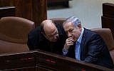 Prime Minister Benjamin Netanyahu speaks with Defense Minister Moshe Ya'alon (L) in the assembly hall of the Knesset on November 24, 2015. (Yonatan Sindel/Flash90)