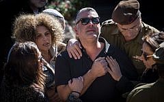 The parents of Ziv Mizrahi at the funeral of the 18-year-old soldier at Mount Herzl Military Cemetery in Jerusalem, on November 24, 2015. Mizrahi was murdered in a stabbing attack at a gas station on the 443 Road, near Jerusalem on November 23, 2015. (Photo by Hadas Parush/Flash90)