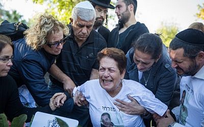 Friends and family mourn at the grave of Corporal Ziv Mizrahi during the funeral ceremony of the 18-year-old attack victim at Mount Herzl Military Cemetery in Jerusalem, on November 24, 2015. (Photo by Hadas Parush/Flash90)