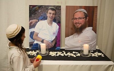 A child looks at the photos of terror victims Rabbi Ya’akov Litman, 40, and his son Netanel, 18 who were killed on November 13, 2015 in a terror attack, at the wedding of Sarah Litman and Ariel Biegel. (Hadas Parush)