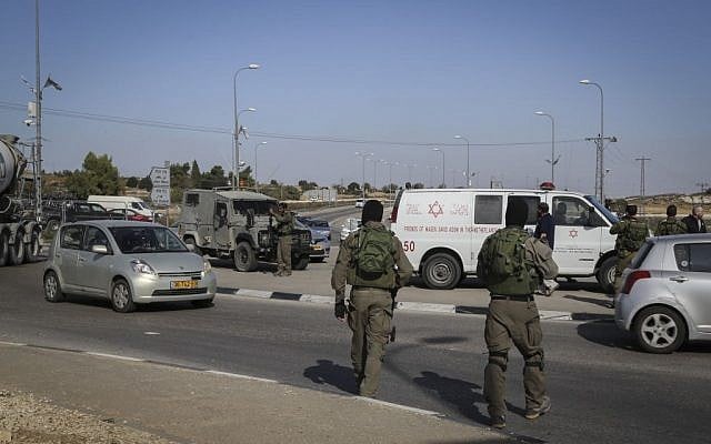 Israeli security forces at the scene where a Palestinian driver rammed his car into Israeli soldiers near Beit Ummar in the West Bank, on November 27, 2015. (Photo by Gershon Elinson/Flash90) Israeli security forces at the scene where a Palestinian driver rammed his car into Israeli soldiers near Beit Ummar in the West Bank, on November 27, 2015. (Photo by Gershon Elinson/Flash90)