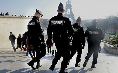 File: French gendarmes officers patrol near the Eiffel Tower, in Paris, Monday Nov. 23, 2015. (AP Photo/Jacques Brinon)