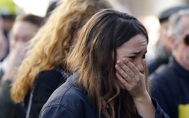A woman cries outside the restaurant on Rue de Charonne, Paris, Sunday, Nov. 15, 2015, where attacks took place on Friday. (AP/Frank Augstein)