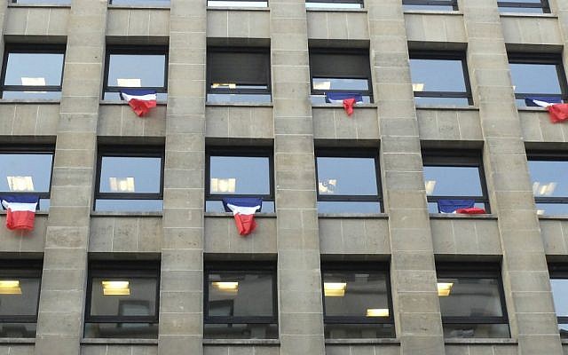 French flags hang from an office building in Paris, Friday, Nov. 27, 2015. (AP Photo/Bertrand Combaldieu) French flags hang from an office building in Paris, Friday, Nov. 27, 2015. (AP Photo/Bertrand Combaldieu)