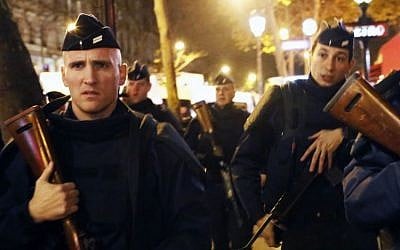 French police patrol at the place de la Republique in Paris, France, Sunday Nov. 15, 2015, two days after over 120 people were killed in a series of shooting and explosions. (AP Photo/Jerome Delay)