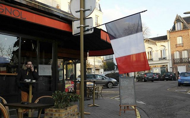 A French flag hangs from a cafe in Ville d'Avray, outside Paris, Friday, Nov. 27, 2015. (AP Photo/Bertrand Combaldieu) A French flag hangs from a cafe in Ville d'Avray, outside Paris, Friday, Nov. 27, 2015. (AP Photo/Bertrand Combaldieu)