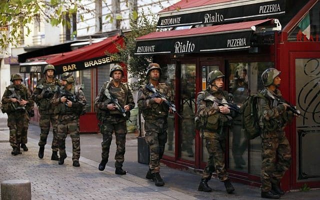 Soldiers operate in St. Denis, a northern suburb of Paris, Wednesday, Nov. 18, 2015 (AP Photo/Francois Mori)