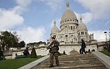 A French soldier patrols near the church of Sacre Coeur, on top of Montmartre hill, in Paris, Wednesday, November 18, 2015. (AP/Daniel Ochoa de Olza)