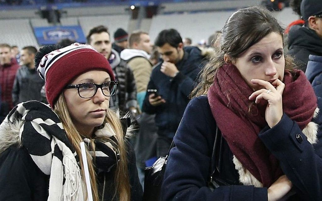 Soccer fans wait on the fitch of the Stade de France stadium after an international friendly soccer match in Saint Denis, outside Paris, Friday, Nov. 13, 2015. (AP/Christophe Ena)