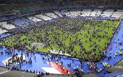 Spectators invade the pitch of the Stade de France stadium after two explosions went off near the international friendly soccer France against Germany, Friday, November 13, 2015. (Photo by AP Photo/Michel Euler)