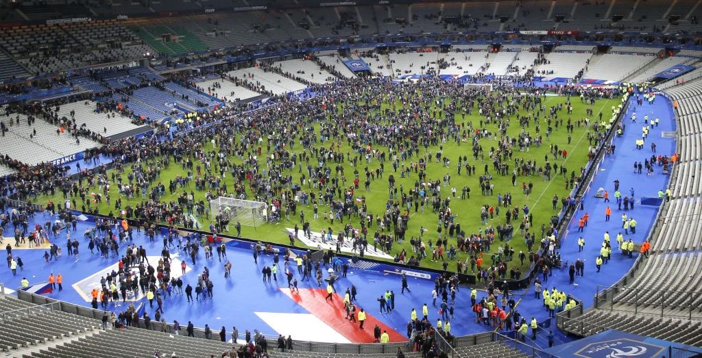 Spectators invade the pitch of the Stade de France stadium after the international friendly soccer France against Germany, Friday, November 13, 2015 in Saint Denis, outside Paris. Multiple fatal attacks throughout the city have prompted President Francois Hollande to announce he was closing the country's borders and declaring a state of emergency. (Photo by AP Photo/Michel Euler) Spectators invade the pitch of the Stade de France stadium after the international friendly soccer France against Germany, Friday, November 13, 2015 in Saint Denis, outside Paris. During the first half of France's soccer match against Germany on Friday, two explosions went off nearby. (Photo by AP Photo/Michel Euler)