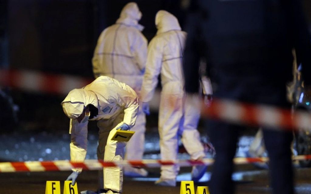 Investigating police officers work outside the Stade de France stadium after an international friendly soccer match France against Germany, in Saint Denis, outside Paris, Friday Nov. 13, 2015. (AP/Michel Euler)