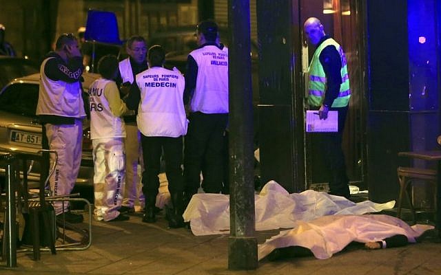 Medical staff stand by victims in a Paris restaurant, Friday, Nov. 13, 2015. (AP/Thibault Camus) 