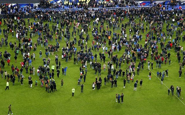 Spectators invade the pitch of the Stade de France stadium after the international friendly soccer France against Germany, Friday, Nov. 13, 2015 in Saint Denis, outside Paris. (AP Photo/Michel Euler) Spectators invade the pitch of the Stade de France stadium after the international friendly soccer France against Germany, Friday, Nov. 13, 2015 in Saint Denis, outside Paris. (AP Photo/Michel Euler)