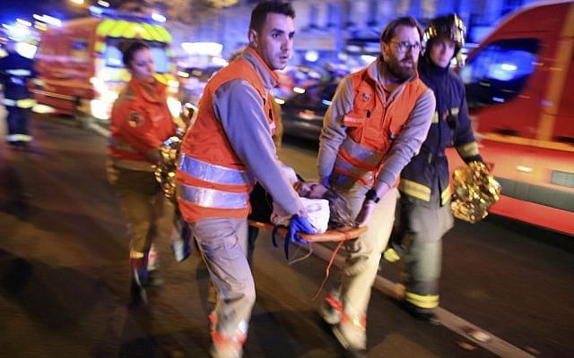 A woman is evacuated from the Bataclan theater after a wave of deadly terror attacks in Paris, Friday November 13, 2015. (AP Photo/Thibault Camus) A woman is evacuated from the Bataclan theater after a wave of deadly terror attacks in Paris, Friday November 13, 2015. (AP Photo/Thibault Camus)