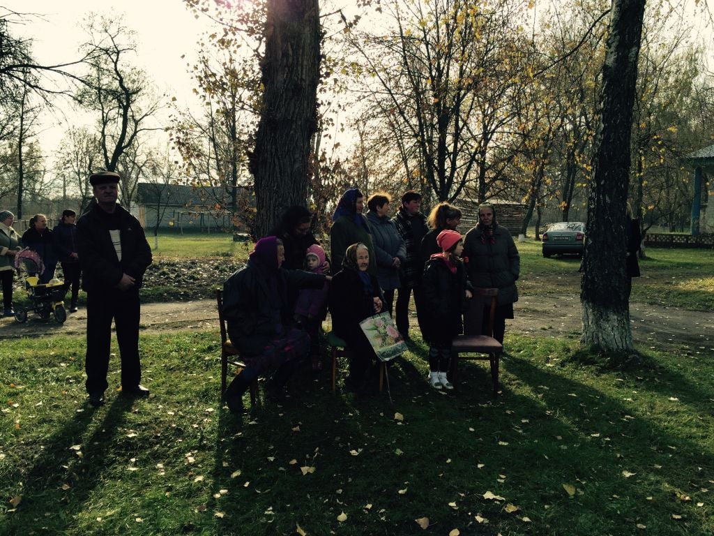 The locals watching a ceremony about Rabin and his family, people who no longer have any connection to this Ukranian town (Jessica Steinberg/Times of Israel)