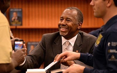 Presidential candidate Ben Carson, M.D., smiles and shakes hands with local residents during his book-signing event in Lake Sumter Landing, The Villages, Florida, on November 2, 2015. (George Horsford/Daily Sun via AP)