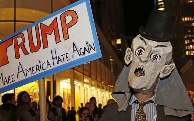 A protester wearing a puppet head with dollar signs in his eyes demonstrates across the street from NBC Studios where "Saturday Night Live," is taped and broadcast, Wednesday, Nov. 4, 2015, in New York. (AP/Kathy Willens) A protester wearing a puppet head with dollar signs in his eyes demonstrates across the street from NBC Studios where "Saturday Night Live," is taped and broadcast, Wednesday, Nov. 4, 2015, in New York. (AP/Kathy Willens)