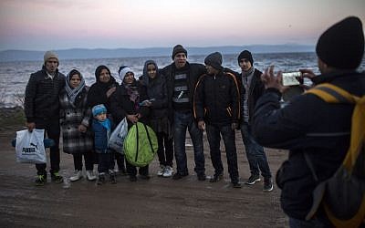 Afghan refugees take a group picture after their arrival on a dinghy, with other refugees and migrants, from the Turkish coast to the northeastern Greek island of Lesbos, November 30, 2015. (AP/Santi Palacios)