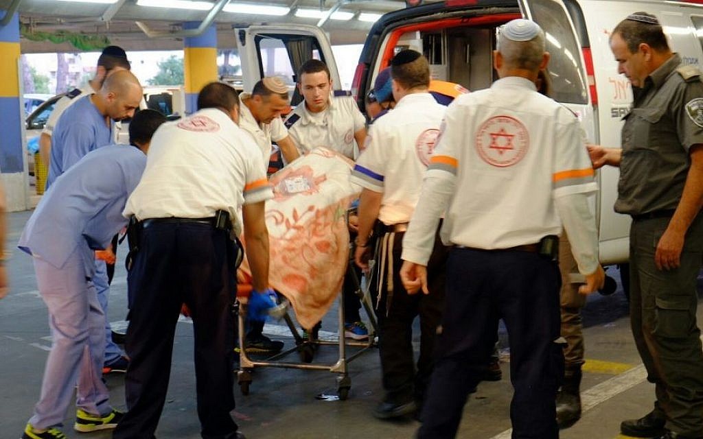 A Border Police officer injured in a car-ramming attack near the Palestinian village of Beit Anun is evacuated to a hospital in Jerusalem on November 1, 2015. (Aba Ritzman/MDA)