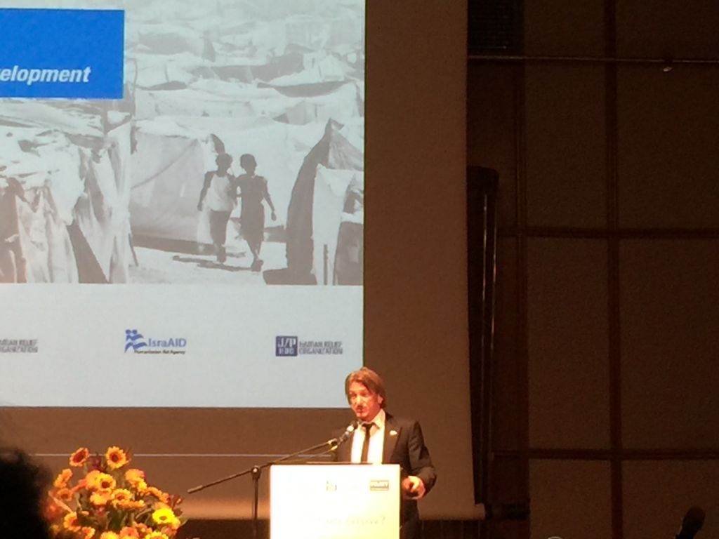 Sean Penn speaking in Tel Aviv at the IsraAID conference on Monday (Jessica Steinberg/Times of Israel)