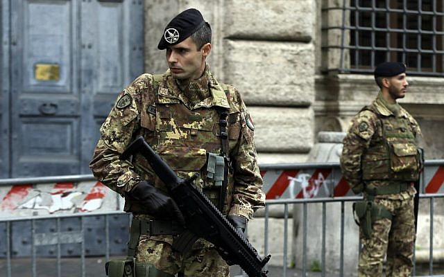 Soldiers stand guard in front of the French embassy in Rome, Saturday, Nov. 14, 2015. (AP Photo/Gregorio Borgia)