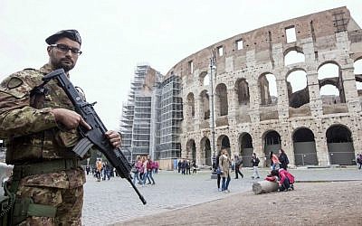 Soldiers patrol in front of the Colosseum in Rome, Saturday, Nov. 14, 2015. (AP Photo/Riccardo De Luca)