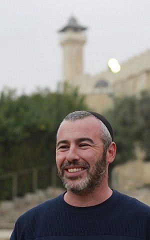 Yishai Fleisher, the international spokesman for the Hebron Jewish community, stands on the steps of the Cave of the Patriarchs, a holy site to both Jews and Muslims on Nov. 5, 2015. (Judah Ari Gross/Times of Israel)
