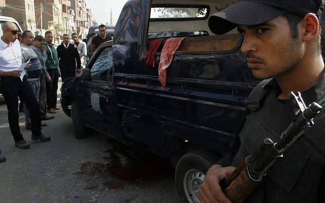 Security personnel and investigators gather at the scene of a drive-by shooting on a security checkpoint that has killed several policemen near Saqqara, home to the 4,600-year-old Step Pyramid, on the outskirts of Cairo, Egypt, Saturday, Nov. 28, 2015. (AP Photo/Ravy Shaker) Security personnel and investigators gather at the scene of a drive-by shooting on a security checkpoint that has killed several policemen near Saqqara, home to the 4,600-year-old Step Pyramid, on the outskirts of Cairo, Egypt, Saturday, Nov. 28, 2015. (AP Photo/Ravy Shaker)