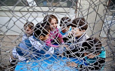In this Saturday, Nov. 28, 2015 photo, Syrian refugee children play at a temporary refugee camp in Irbil, northern Iraq. Some 240,000 refugees who fled the fighting in Syria now live in Iraq. Their children are neither citizens of Syria, their families’ country of origin, or of Iraq, the country where they now live. (Seivan M. Salim/AP)
