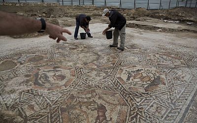 Employees of Israel’s antiquities authority work on a 1,700-year-old Roman-era mosaic floor in Lod, Israel, Monday, Nov. 16, 2015 (AP Photo/Ariel Schalit)