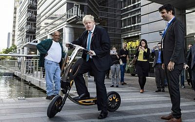 Mayor of London Boris Johnson rides an electric scooter during his visit to Tel Aviv, Israel, Monday, Nov. 9, 2015. (AP Photo/Dan Balilty)