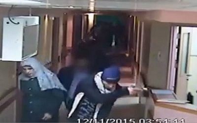 This image made from CCTV video released by Al-Ahli Hospital shows an arrest raid seeking a stabbing suspect by Israeli forces, one disguised as a pregnant Muslim woman, and others disguised in fake beards in Hebron on Thursday, Nov. 12, 2015. (Al-Ahli Hospital via AP) 