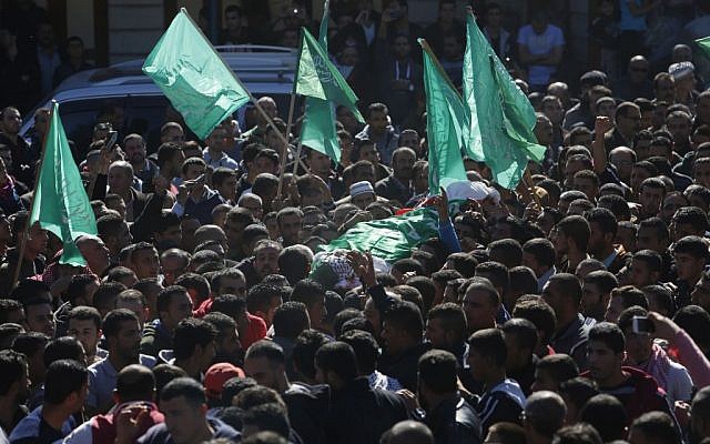 Palestinian mourners carry the body of 27-year-old Abdallah Shalaldeh, during his funeral in the West Bank village of Sa'ir, near Hebron, Thursday, Nov. 12, 2015. (AP Photo/ Nasser Shiyoukhi)